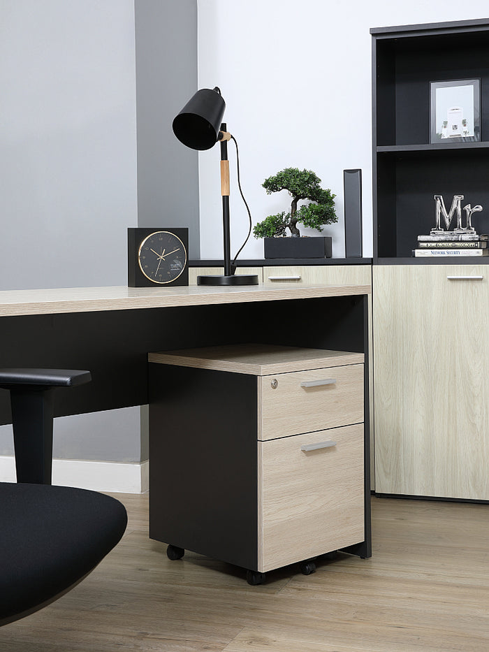 Mobile pedestal cabinet with light wood drawers and black side panels, on caster feet