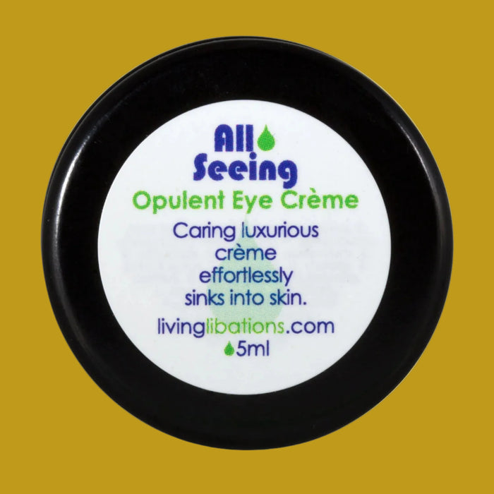 A black pot with a white label that reads 'All Seeing Opulent Eye Crème', with blue and green text detailing the product's benefits and the brand's website.