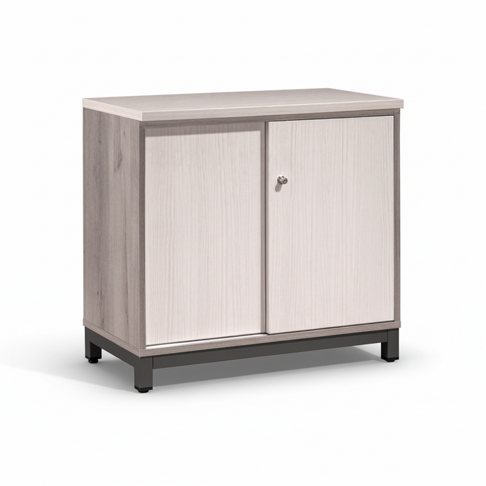 Low sliding door cabinet with light wood doors, gray sides, and dark base legs.