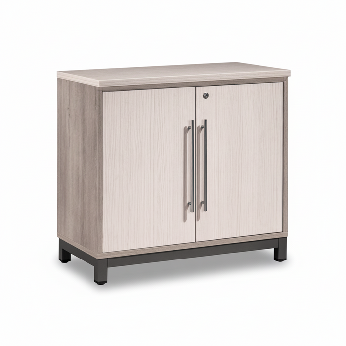 Low swing door cabinet in light wood veneer with two vertical metal handles