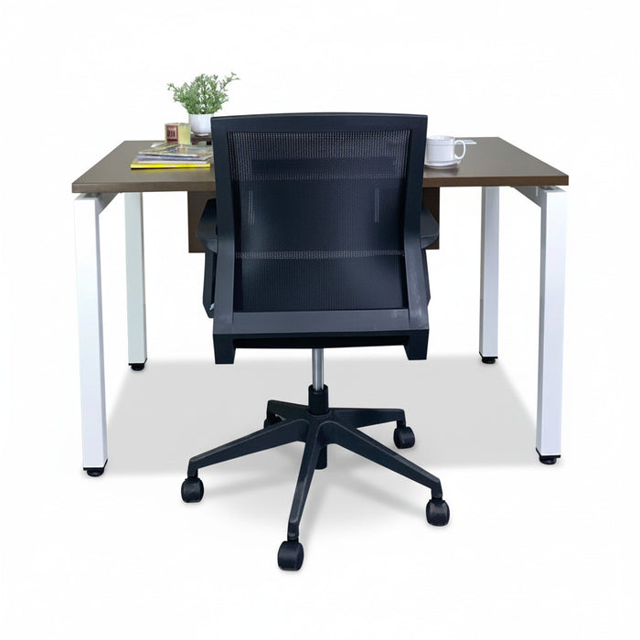 Walnut office desk with white legs and dark mesh office chair