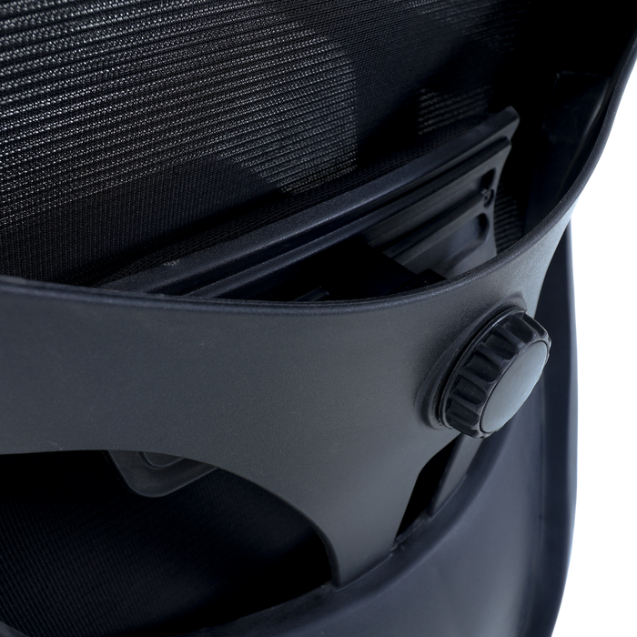 Black armrest and mesh back panel on executive chair with textured seat upholstery
